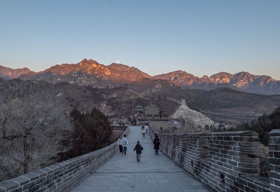 Tourists walking on the Great Wall of China at Mutianyu sunset