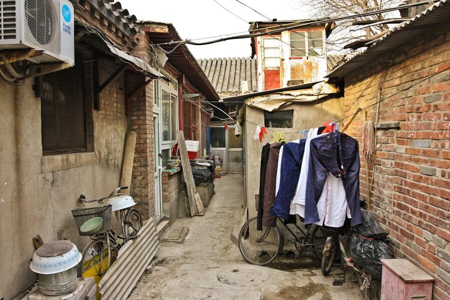 Bicycle in a Beijing hutong alley with grey brick walls