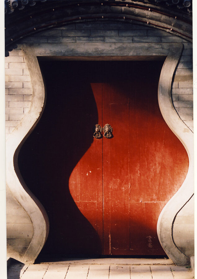 Beijing hutong red door with brass knockers