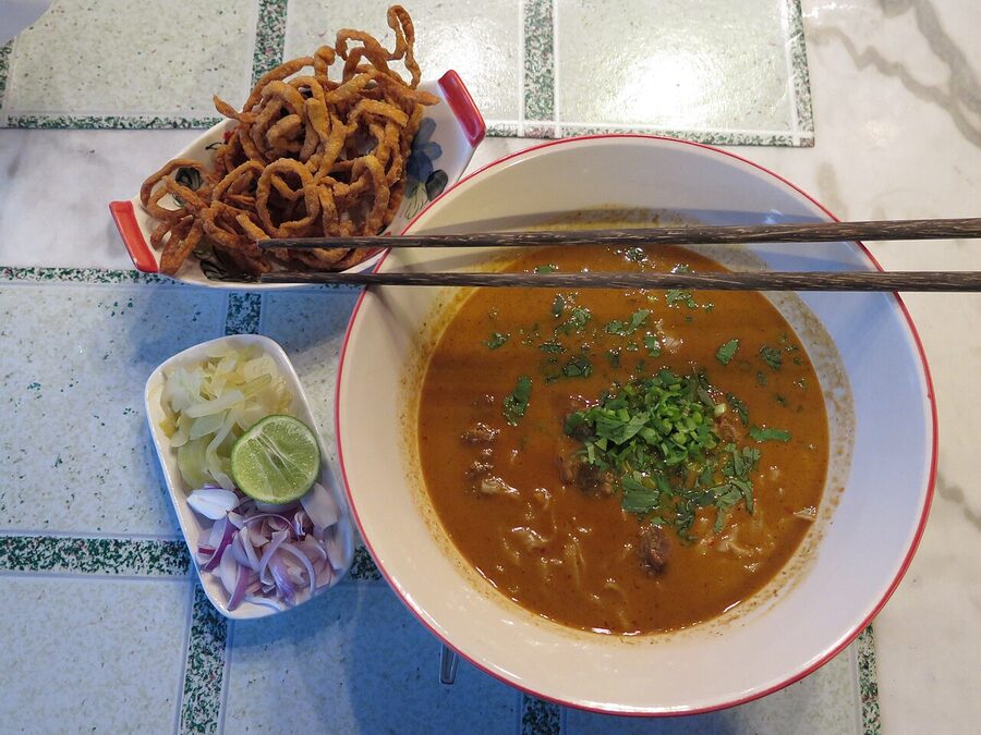 Bowl of khao soi noodles with crispy topping