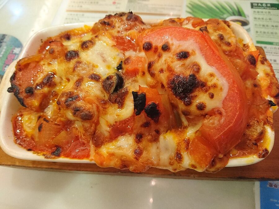 Baked pork chop rice zi yun faan with tomato sauce and melted cheese