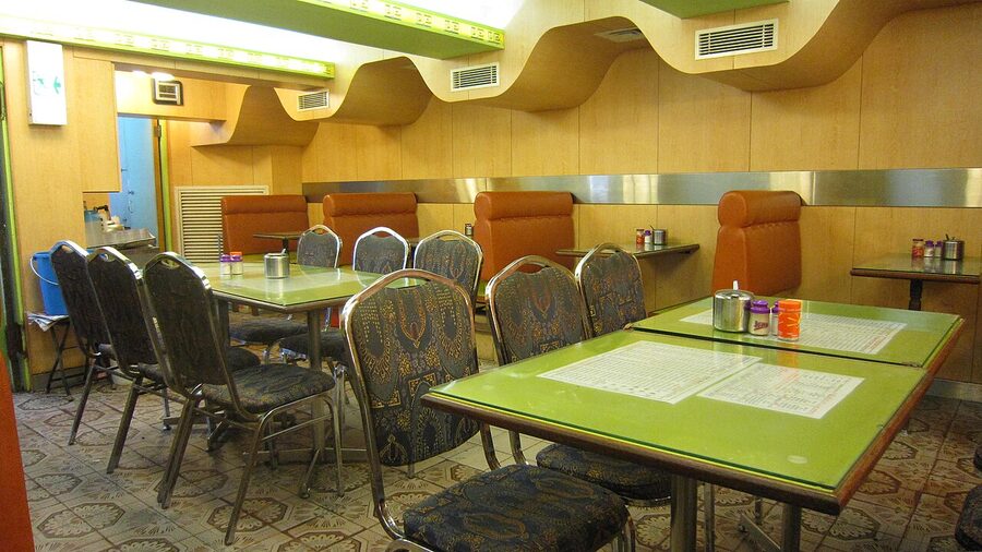 Interior of a Hong Kong cha chaan teng with booth seating and menu boards
