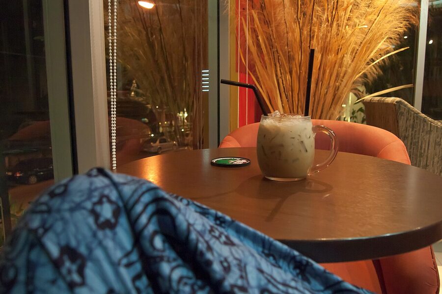 Iced coffee served in a glass at a Chiang Mai café, dark espresso pulled over ice with milk separating