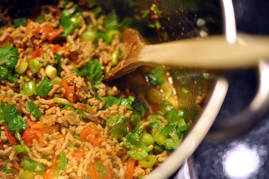 Nam prik ong chili dip made from tomato and pork, served with sticky rice and fresh vegetables in northern Thailand