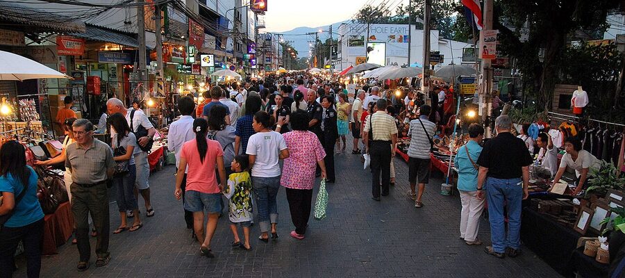 Dense crowds on the Sunday Walking Street in Chiang Mai old city, stretching down Ratchadamnoen Road