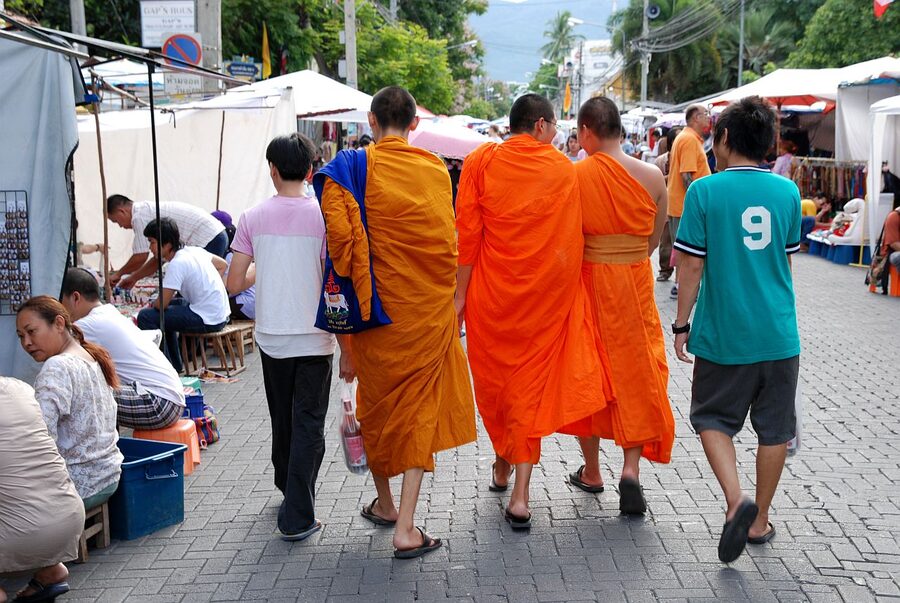 Food stalls and temple courtyard packed with diners during the Sunday Walking Street in Chiang Mai