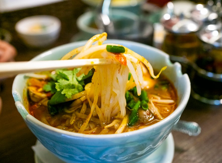 Thai rice-noodle soup topped with fresh herbs, lime and chili paste