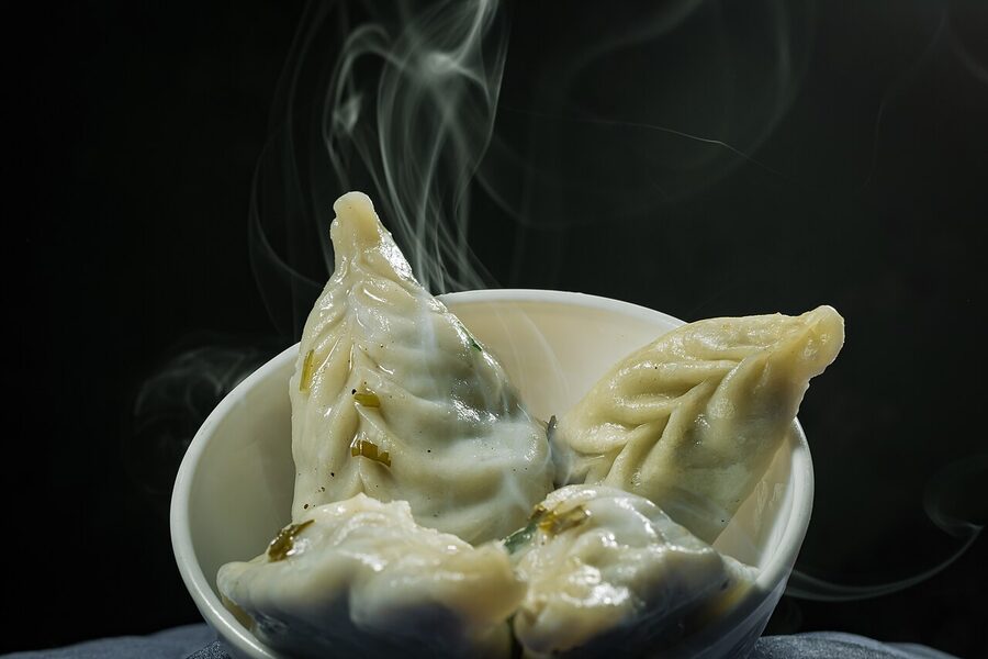 Plate of steamed Himalayan momos with dipping sauce