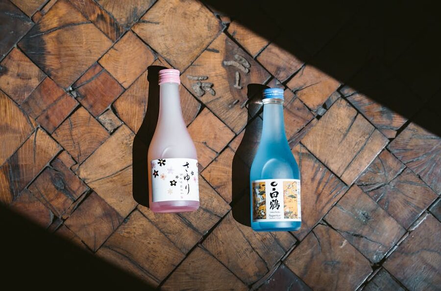 Two Japanese sake bottles in pink and blue
