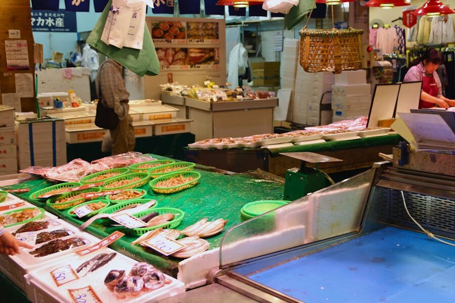 A seafood stall at a Japanese market displaying fresh fish and shellfish