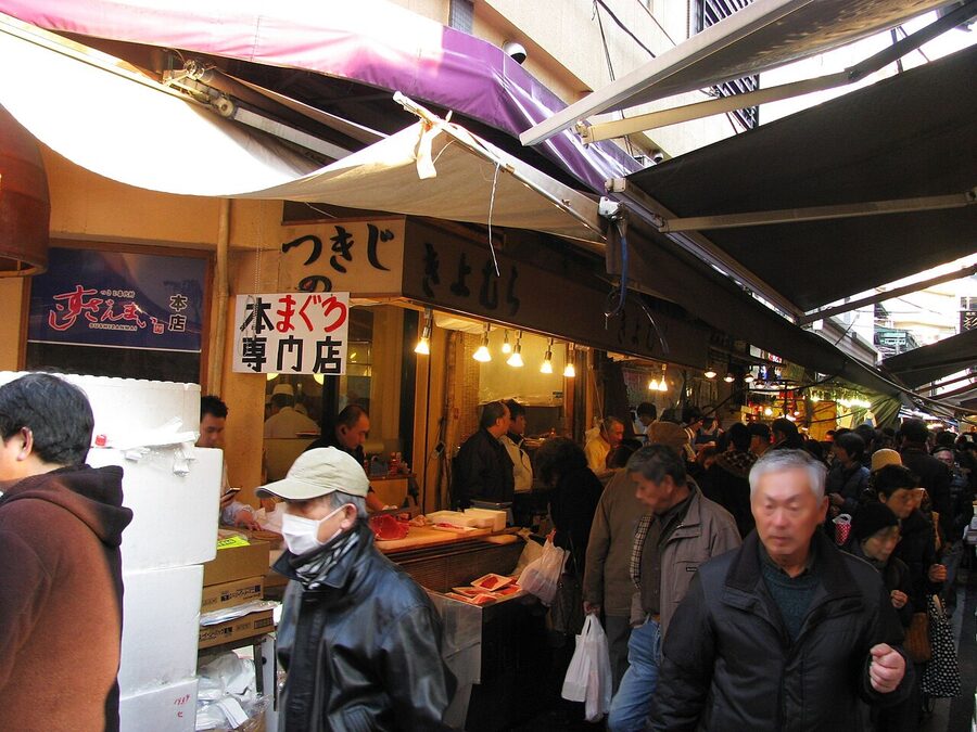 Vendors and food stalls lining the Tsukiji Outer Market in Tokyo