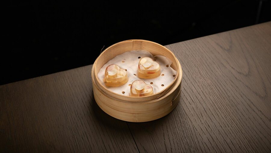 Heart-shaped dim sum pieces in a bamboo steamer