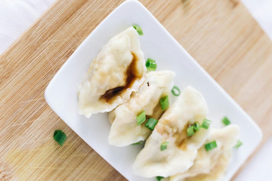 Chinese dumplings with soy sauce and chopped scallions