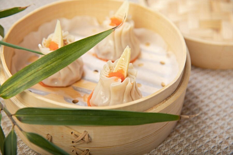 Gourmet shrimp dumplings with bamboo leaves in a steamer