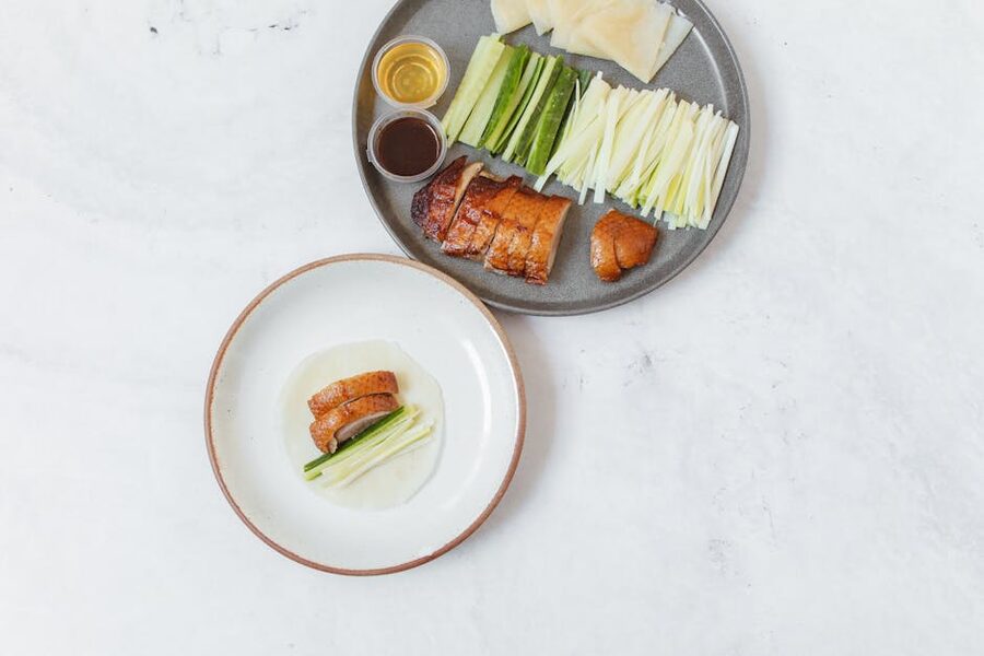 Sliced Peking duck served with cucumbers, scallions and pancakes at a Beijing restaurant