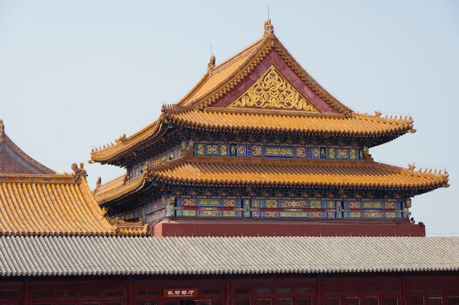 Detailed view of the Forbidden City rooftop eaves with traditional Chinese yellow tiles and decorative elements, Beijing