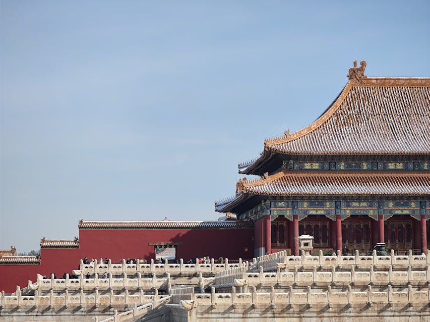 The Forbidden City rooftops dusted with snow during a Beijing winter