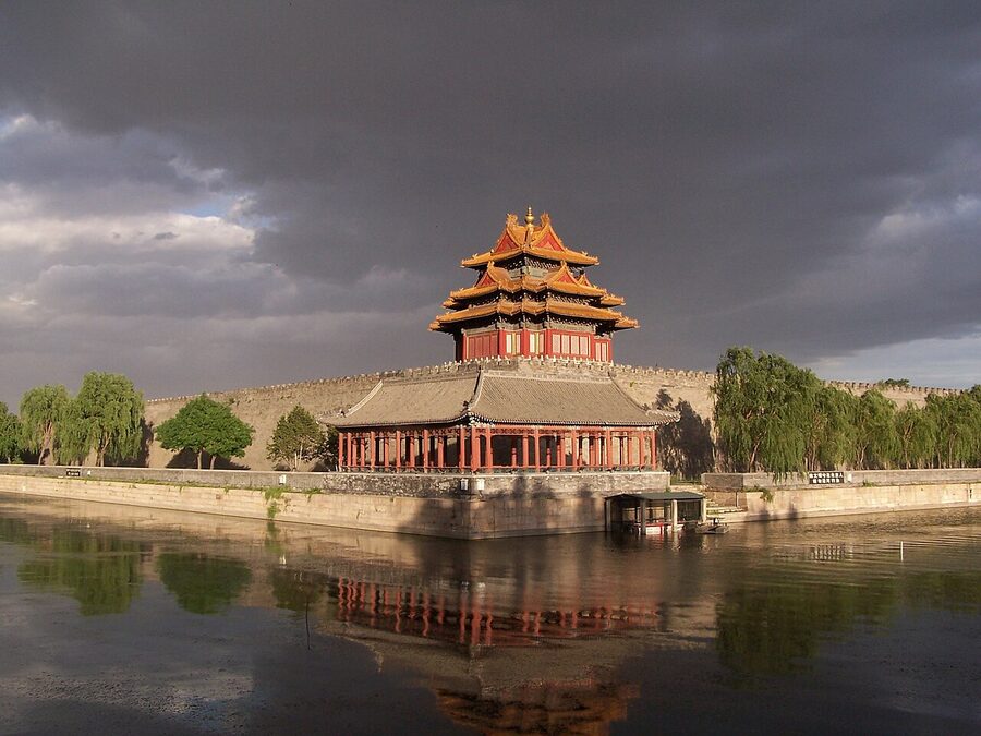 Sunset over the Forbidden City northwest corner tower, with red walls and golden eaves, Beijing