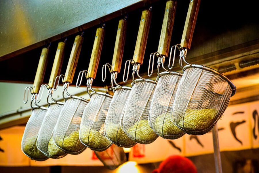 Ramen noodle strainers hanging in a Japanese ramen kitchen