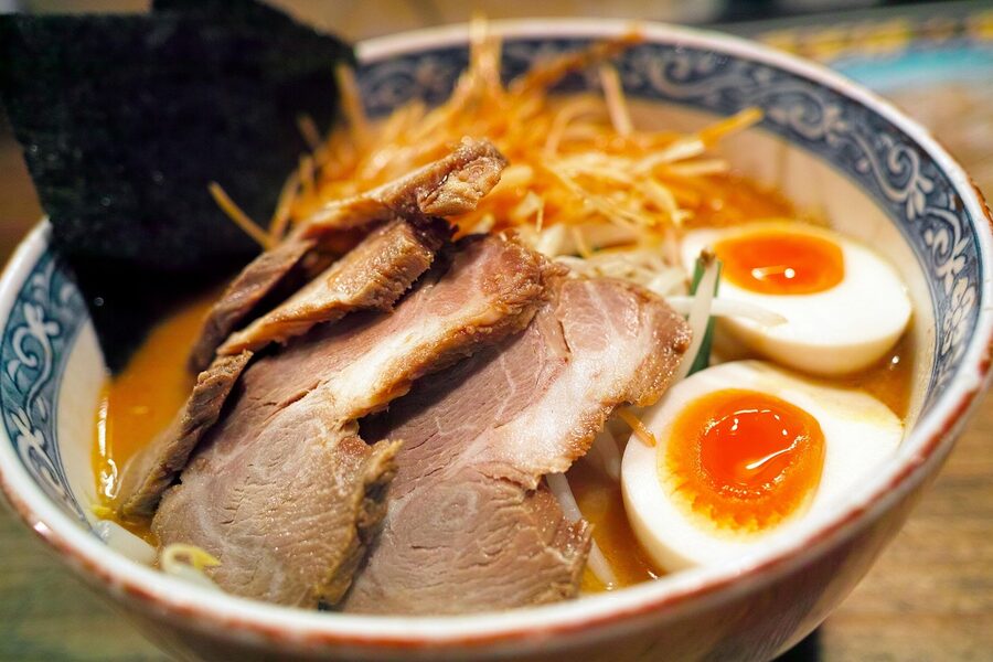 Bowl of tonkotsu ramen with chashu pork slices and soft-boiled egg