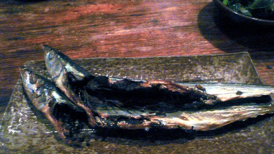 Kusaya fermented dried fish being grilled on a plate
