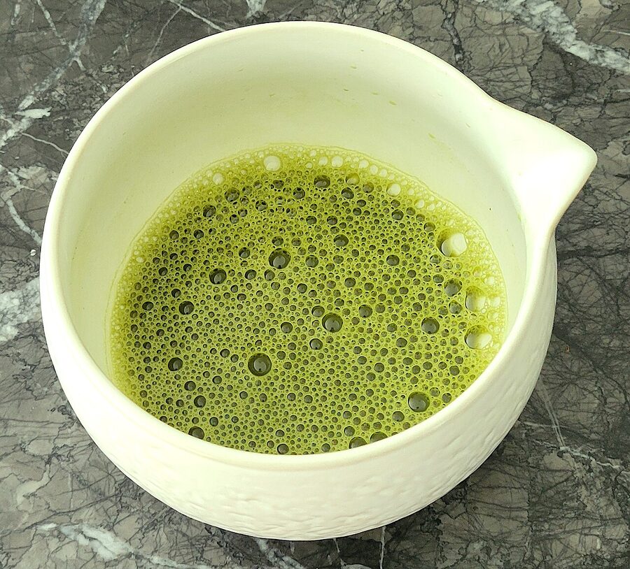 Matcha tea in a black ceramic bowl