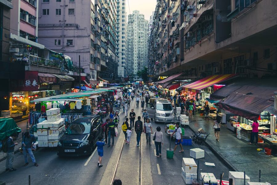 Hong Kong street market at twilight with signs and pedestrians