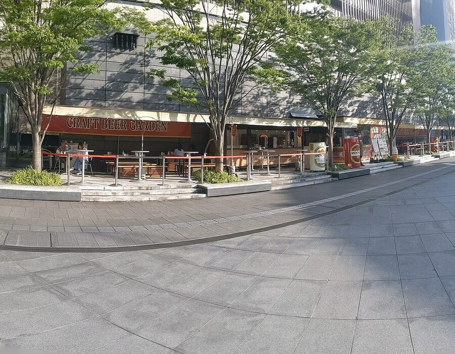 Craft Beer Garden rooftop at Osaka Station's North Gate Building, wooden seating and beer tents