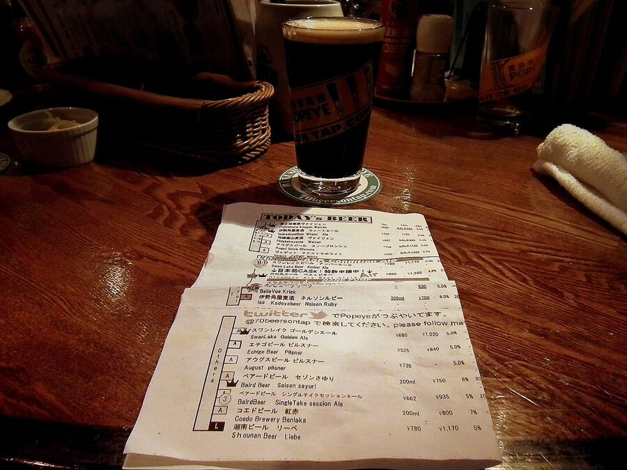Blackboard beer list of 40 taps and a pint of Popeye Black Beer at Popeye in Ryogoku