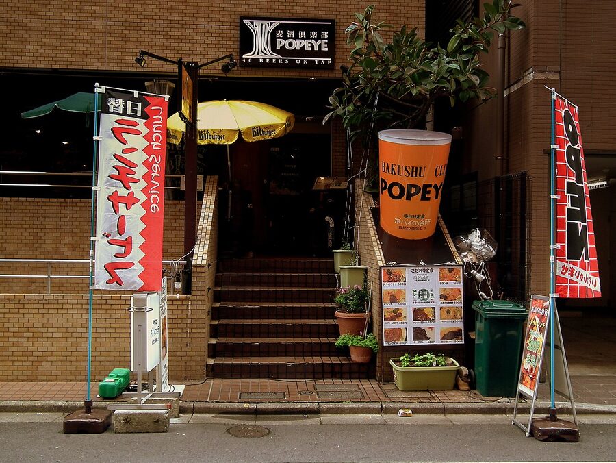 Beer Club Popeye taproom exterior in Ryogoku, Tokyo, long wooden bar lined with tap handles