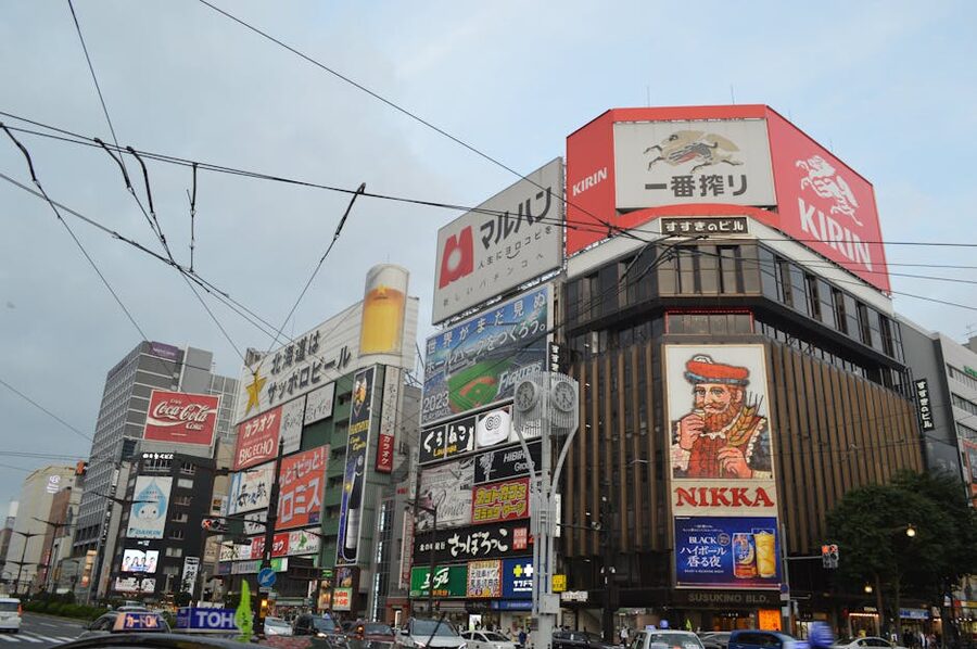Susukino intersection in central Sapporo at night with neon signs and taxis