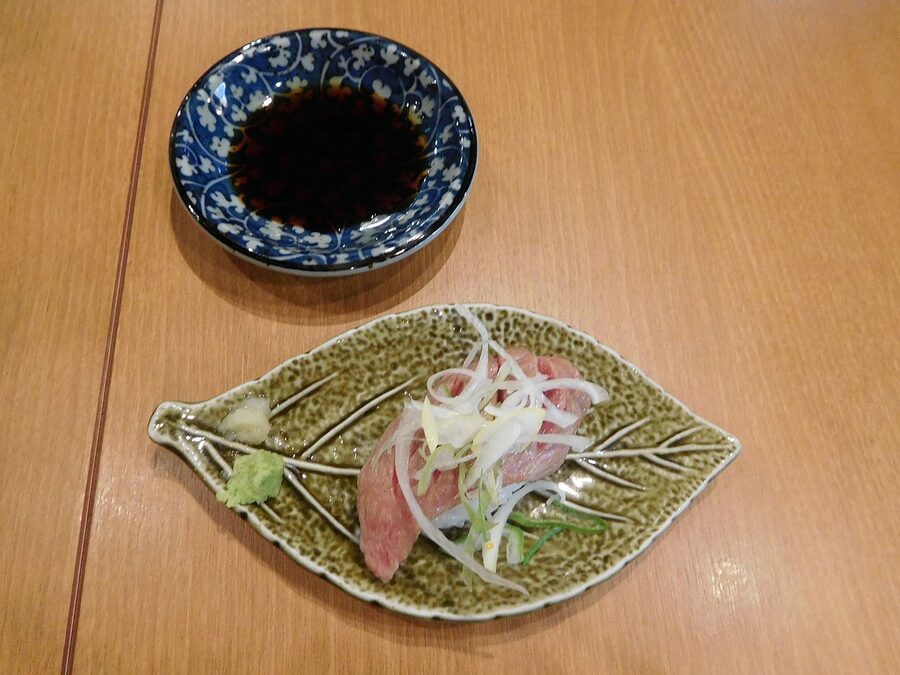 Hida beef nigiri sushi served on a rice cracker