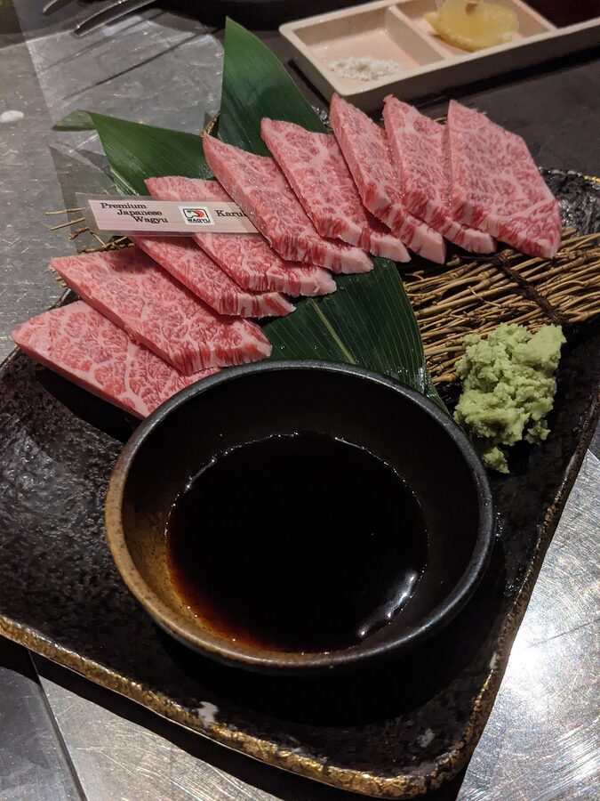 Sliced wagyu beef arranged for a tasting plate