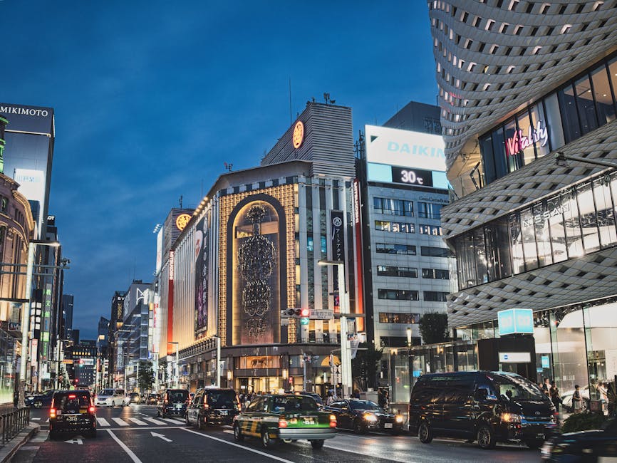 Evening view of a Ginza street in Tokyo with neon signs and high-rise buildings