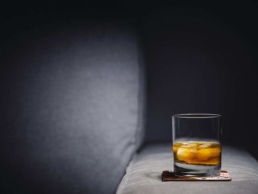 Whisky on the rocks in a tumbler with clear ice cubes