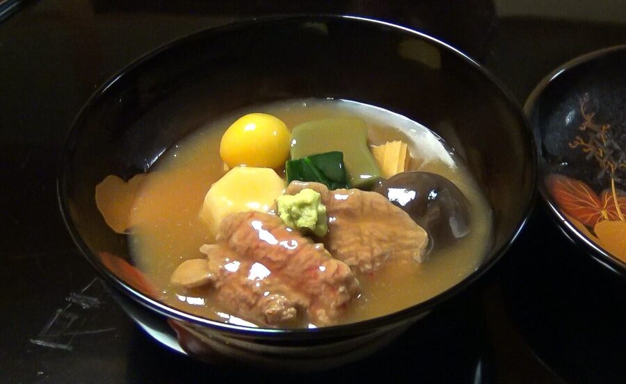 Bowl of jibuni duck stew with vegetables