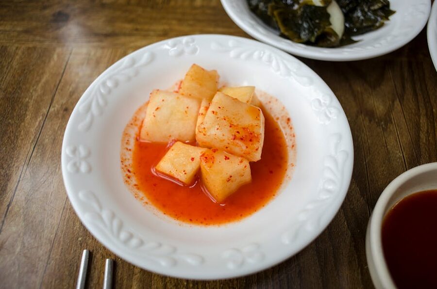 Korean radish kimchi kkakdugi in a white ceramic bowl