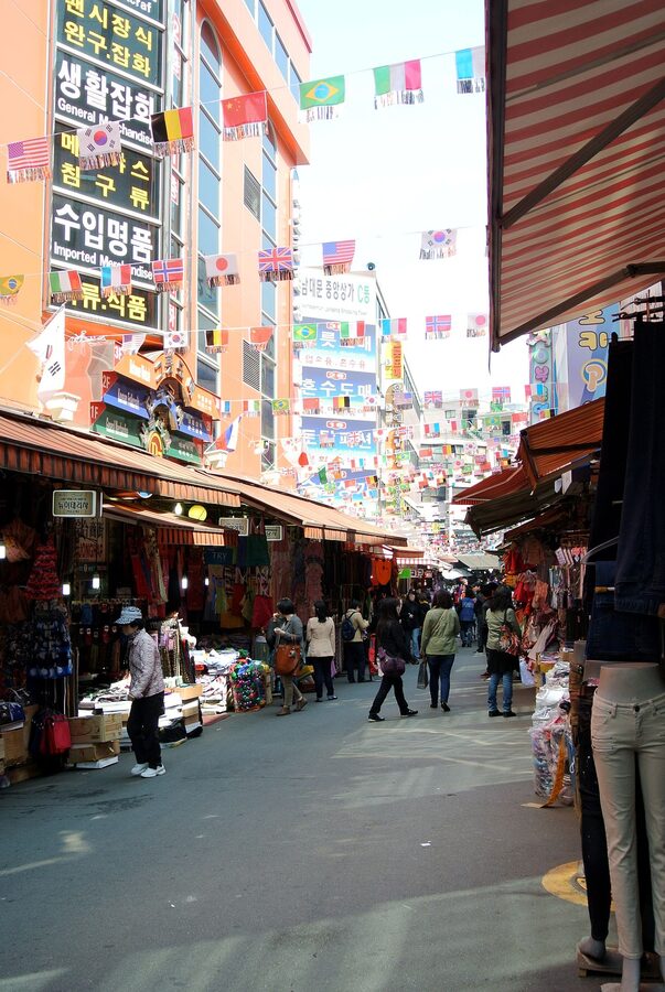 A food alley inside Namdaemun Market in Seoul with stalls and diners
