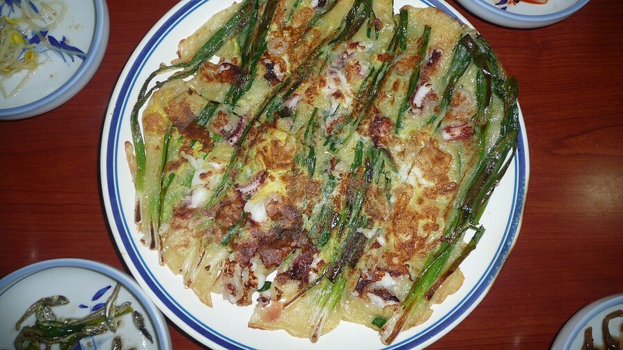 Korean pajeon scallion pancake golden brown on a plate