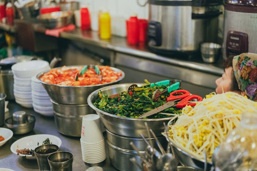 Colorful array of Korean street food dishes at a busy Seoul food market