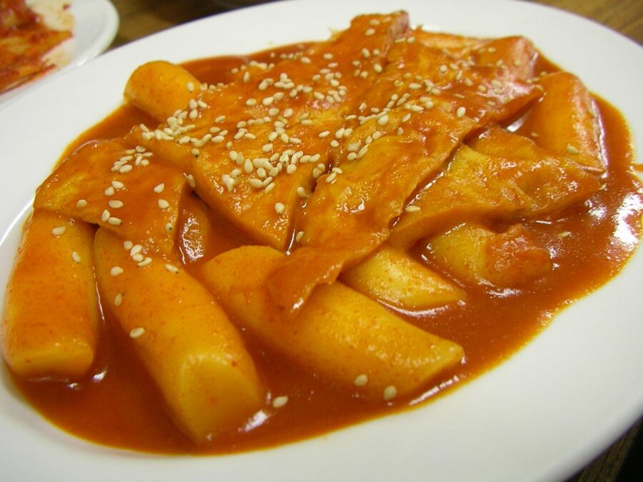 Spicy Korean tteokbokki rice cakes simmering in red gochujang sauce