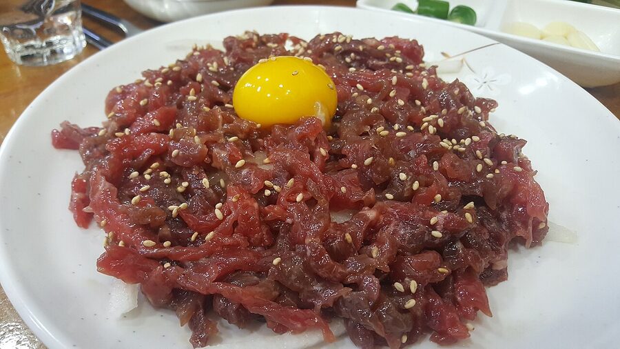 Korean yukhoe raw beef tartare with egg yolk and pear at Gwangjang Market