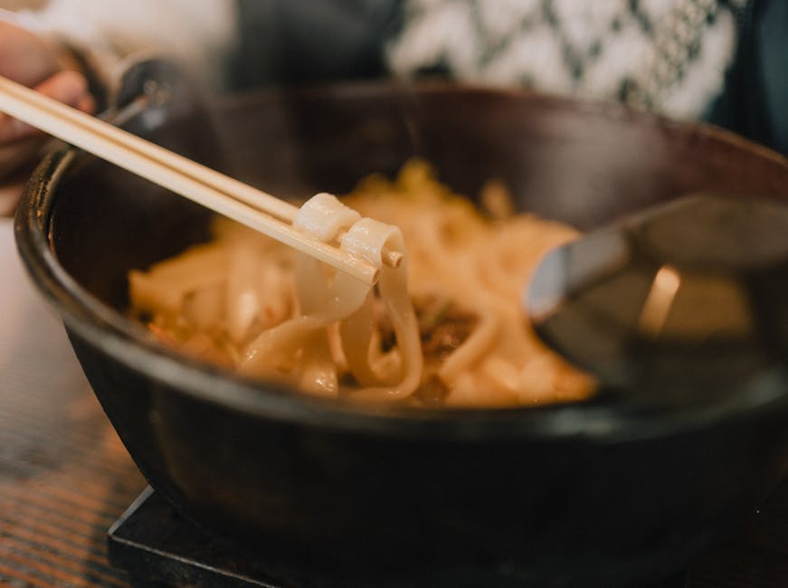 Bowl of kitsune udon noodles with chopsticks