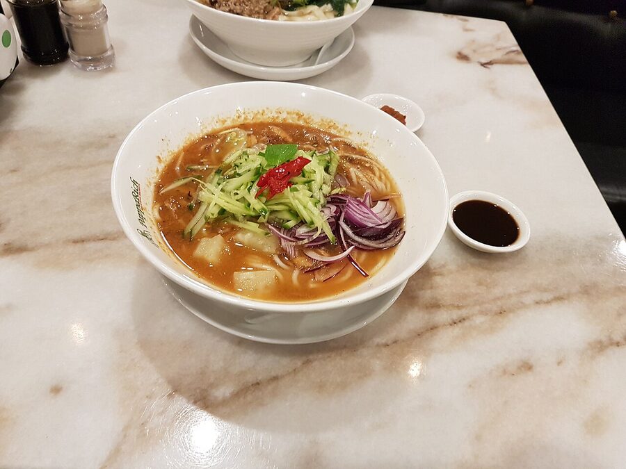 Bowl of Penang assam laksa with tamarind broth and mackerel