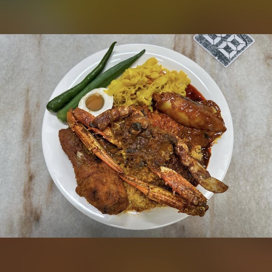 Nasi kandar plate with rice and multiple curries