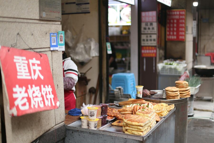Chinese street food stall with traditional pancakes being cooked