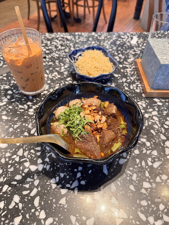 Stack of small boat noodle bowls at a Bangkok stall