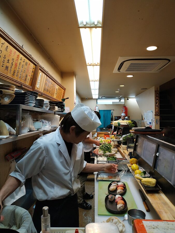 Japanese sushi chefs working a counter