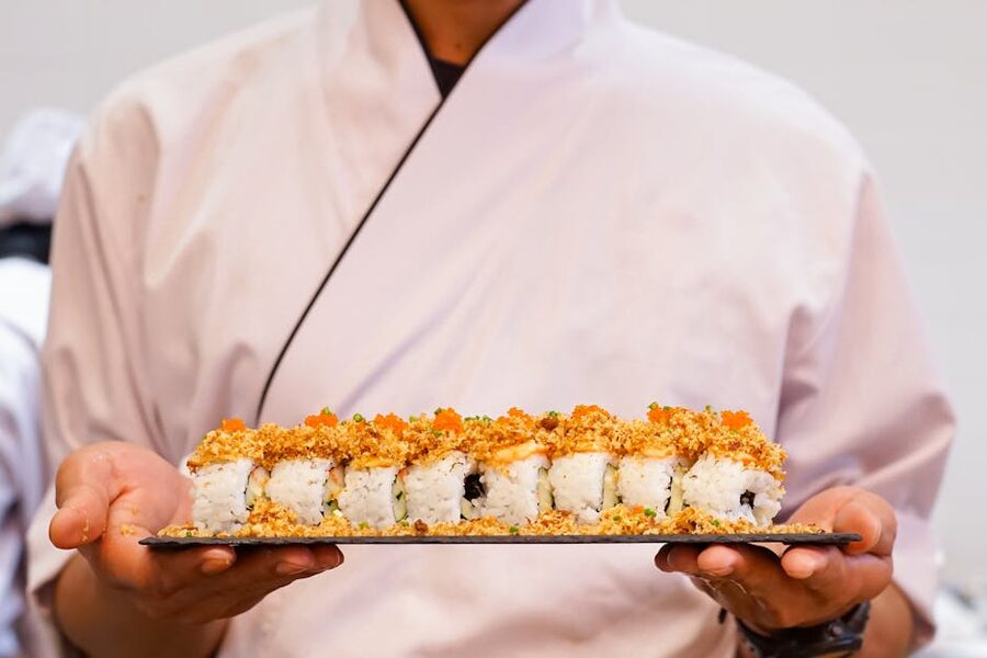 Sushi chef hands forming nigiri
