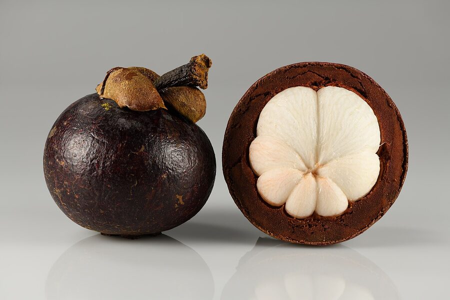 Mangosteen whole and opened showing white segments